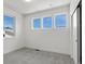 Clean bedroom featuring neutral carpet, white walls, and three windows with a view at 5604 Grandville Ave, Longmont, CO 80503