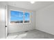 Bright bedroom featuring neutral carpet, white walls, and a large window with scenic views at 5604 Grandville Ave, Longmont, CO 80503