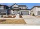 Charming two-story home with a modern gray and white facade, manicured lawn, and attached garage at 5604 Grandville Ave, Longmont, CO 80503