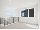 Hallway featuring a modern black railing and abundant natural light from windows at 5604 Grandville Ave, Longmont, CO 80503