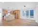 Modern kitchen boasts stainless steel appliances, wood cabinets, large island, and hardwood floors at 5604 Grandville Ave, Longmont, CO 80503