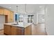Open kitchen with stainless steel appliances, a center island, and sliding glass doors to the backyard patio at 5604 Grandville Ave, Longmont, CO 80503