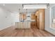 Spacious kitchen featuring hardwood floors, stainless steel appliances, island, and light wood cabinetry at 5604 Grandville Ave, Longmont, CO 80503