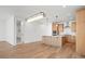 Open-concept living space with a modern kitchen, hardwood floors, bright lighting, and spacious layout at 5604 Grandville Ave, Longmont, CO 80503