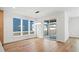 Bright living space featuring hardwood floors, large windows, sliding glass doors, and an open floor plan at 5604 Grandville Ave, Longmont, CO 80503