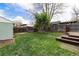 Spacious backyard featuring lush lawn, mature trees, and tiered wooden decks at 2074 S Emerson St, Denver, CO 80210