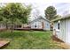 A back yard features tiered wooden decks, a patio, and mature trees at 2074 S Emerson St, Denver, CO 80210