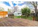 Large back deck leading to a spacious fenced-in backyard with detached shed at 2074 S Emerson St, Denver, CO 80210