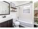 Bathroom featuring floating shelves, large mirror, and a shower/tub combination at 2074 S Emerson St, Denver, CO 80210