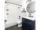 Bathroom featuring a dark vanity, subway tile, and updated fixtures throughout at 2074 S Emerson St, Denver, CO 80210