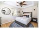 Cozy bedroom with a king bed, tray ceiling, and large window offering plenty of natural light at 2074 S Emerson St, Denver, CO 80210