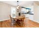 Cozy dining area featuring a glass table and hardwood floors, open to the kitchen at 2074 S Emerson St, Denver, CO 80210