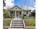 Charming home featuring a landscaped front yard with a wrought iron fence and a welcoming porch at 2074 S Emerson St, Denver, CO 80210