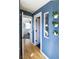 Hallway with a pop of blue wall color, hardwood flooring, and a peek into the bedroom at 2074 S Emerson St, Denver, CO 80210