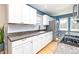 Well-lit kitchen featuring granite countertops, white cabinets, subway tile backsplash, and stainless steel appliances at 2074 S Emerson St, Denver, CO 80210