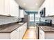 Modern kitchen with white cabinets, subway tile backsplash, and stainless steel appliances at 2074 S Emerson St, Denver, CO 80210