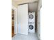Laundry room featuring stacked washer and dryer with tiled flooring at 2074 S Emerson St, Denver, CO 80210