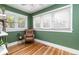 Living room featuring green walls, hardwood flooring and a big window at 2074 S Emerson St, Denver, CO 80210