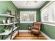 Living room featuring green walls, hardwood flooring, built in shelves, and a big window at 2074 S Emerson St, Denver, CO 80210