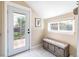 Mudroom with patterned floors, a bench, natural light, and access to the backyard at 2074 S Emerson St, Denver, CO 80210