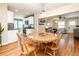 Open concept living space with dining area, kitchen, and living room featuring hardwood floors and bright lighting at 2074 S Emerson St, Denver, CO 80210