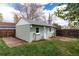 Charming outbuilding with a fenced-in yard and adjacent back deck at 2074 S Emerson St, Denver, CO 80210