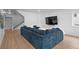 Finished basement with sectional sofa and stairs at 9524 Fork Bluff Pt, Lone Tree, CO 80124