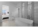 Spa-like bathroom with a freestanding tub and views of the mountains at 9524 Fork Bluff Pt, Lone Tree, CO 80124