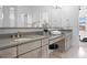 Elegant bathroom with double sinks, a large mirror, and modern fixtures at 9524 Fork Bluff Pt, Lone Tree, CO 80124