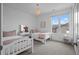 Bright bedroom with two twin beds and window at 9524 Fork Bluff Pt, Lone Tree, CO 80124