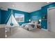 Bright bedroom with teal walls and unique hanging bed at 9524 Fork Bluff Pt, Lone Tree, CO 80124