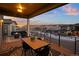 Covered deck with outdoor seating and mountain views at 9524 Fork Bluff Pt, Lone Tree, CO 80124