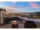 Relaxing deck with fire pit, offering scenic sunset views at 9524 Fork Bluff Pt, Lone Tree, CO 80124