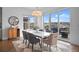 Modern dining room with a white table, stylish chairs, and access to a deck at 9524 Fork Bluff Pt, Lone Tree, CO 80124