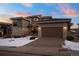 Stunning modern home with a large garage and snow-covered landscaping at 9524 Fork Bluff Pt, Lone Tree, CO 80124