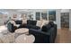 Open concept great room with sectional sofa and fireplace at 9524 Fork Bluff Pt, Lone Tree, CO 80124