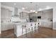 Modern kitchen with a large island, stainless steel appliances, and white quartz countertops at 9524 Fork Bluff Pt, Lone Tree, CO 80124