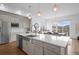 Modern kitchen with a large island, stainless steel appliances, and white quartz countertops at 9524 Fork Bluff Pt, Lone Tree, CO 80124