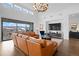 Spacious living room with a large sectional sofa and sliding glass doors at 9524 Fork Bluff Pt, Lone Tree, CO 80124