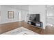 Upstairs hallway with TV and hardwood floors at 9524 Fork Bluff Pt, Lone Tree, CO 80124