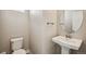Powder room featuring a pedestal sink, decorative mirror, and tile flooring at 21295 E 61St Dr, Aurora, CO 80019