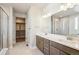 Modern bathroom features double vanity, walk-in glass shower, and large mirrors for an open feel at 21295 E 61St Dr, Aurora, CO 80019