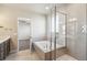 Modern bathroom featuring glass shower, soaking tub, modern fixtures and tile floors at 21295 E 61St Dr, Aurora, CO 80019