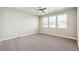 Spacious bedroom with neutral carpet, ceiling fan, and multiple windows offering great natural light at 21295 E 61St Dr, Aurora, CO 80019