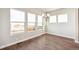 Sunlit Dining room with wood floors, modern light fixture, and large windows with views at 21295 E 61St Dr, Aurora, CO 80019