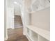 Entryway with coat rack, storage bench, hardwood floors and stair access at 21295 E 61St Dr, Aurora, CO 80019