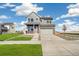 Charming two-story home with a well-maintained lawn and an attached two-car garage at 21295 E 61St Dr, Aurora, CO 80019