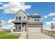 Attractive two-story home with a brick facade and a well-manicured lawn at 21295 E 61St Dr, Aurora, CO 80019