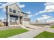Stylish two-story home with a modern design, featuring a covered porch and two-car garage at 21295 E 61St Dr, Aurora, CO 80019
