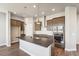 Charming kitchen features stainless steel appliances, a central island and modern finishes at 21295 E 61St Dr, Aurora, CO 80019